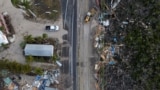 A drone view shows a bulldozer removing debris from a road after Hurricane Milton made landfall, in Matlacha, Florida, Oct. 10, 2024.