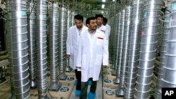 FILE - Then-President Mahmoud Ahmadinejad visits the Natanz Uranium Enrichment Facility in Iran, April 8, 2008. Natanz is one site where Iran is expanding its nuclear program, a move criticized on June 15, 2024, by some European nations. (Iranian President's Office via AP)