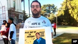 Connor Gorman of Davis, Calif., joins a rally on behalf of Cambodian refugee Tith Ton, who is awaiting parole from a murder conviction but could be deported to Cambodia, at the California Capitol in Sacramento, Nov. 1, 2019.