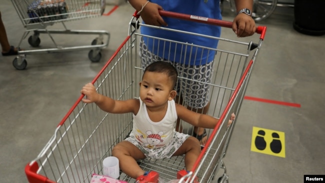 A baby is seen in a store after the government eased some protective measures following the coronavirus disease (COVID-19) outbreak, in Bangkok, Thailand on June 19, 2020. (REUTERS/Jorge Silva/File Photo)