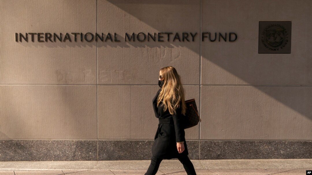 FILE - Signage is seen on the International Monetary Fund building, in Washington, April 5, 2021.