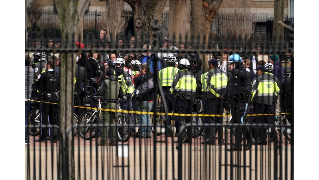 FILE - Police keep watch on the group Antifacist Action during a rally outside of the White House in Washington, Jan. 5, 2019.