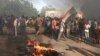 Sudanese men protest against a military coup that overthrew the transition to civilian rule, in the al-Shajara district in southern Khartoum, on October 25, 2021.