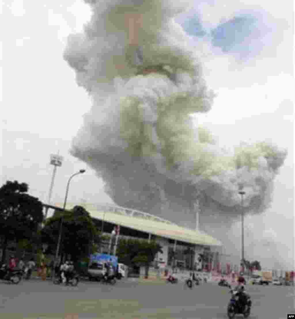 In this Wednesday, Oct. 6, 2010 photo, a giant column of smoke billows over the sky after fireworks intended for upcoming Hanoi's 1,000th birthday celebration exploded in Hanoi.