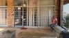 FILE - A man sits outside a closed clinic in Soweto, South Africa, Jan. 30, 2025. President Donald Trump signed an executive order Feb. 7, 2025, that will freeze aid to South Africa because of its effort to address wrongs of its racist apartheid era.