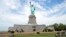 In this June 26, 2013 photo provided by the National Park Service, workers on Liberty Island install sod around the national monument which is set to re-open on the 4th of July, in New York. 