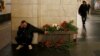 A man reacts next to a memorial site for the victims of a blast in St. Petersburg metro, at Tekhnologicheskiy institut metro station in St. Petersburg, Russia, April 4, 2017. 