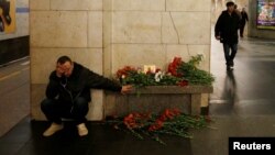 A man reacts next to a memorial site for the victims of a blast in St. Petersburg metro, at Tekhnologicheskiy institut metro station in St. Petersburg, Russia, April 4, 2017. 