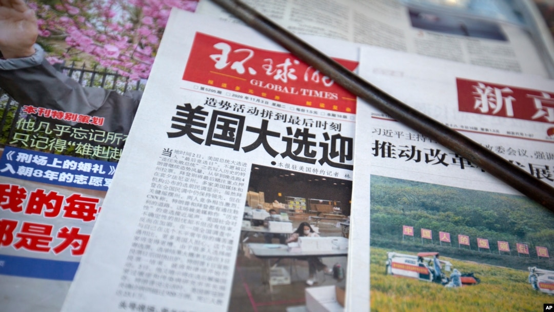 A copy of the Chinese state-run Global Times newspaper with a headline about the U.S. presidential elections is displayed at a newsstand in Beijing, Tuesday, Nov. 3, 2020. 