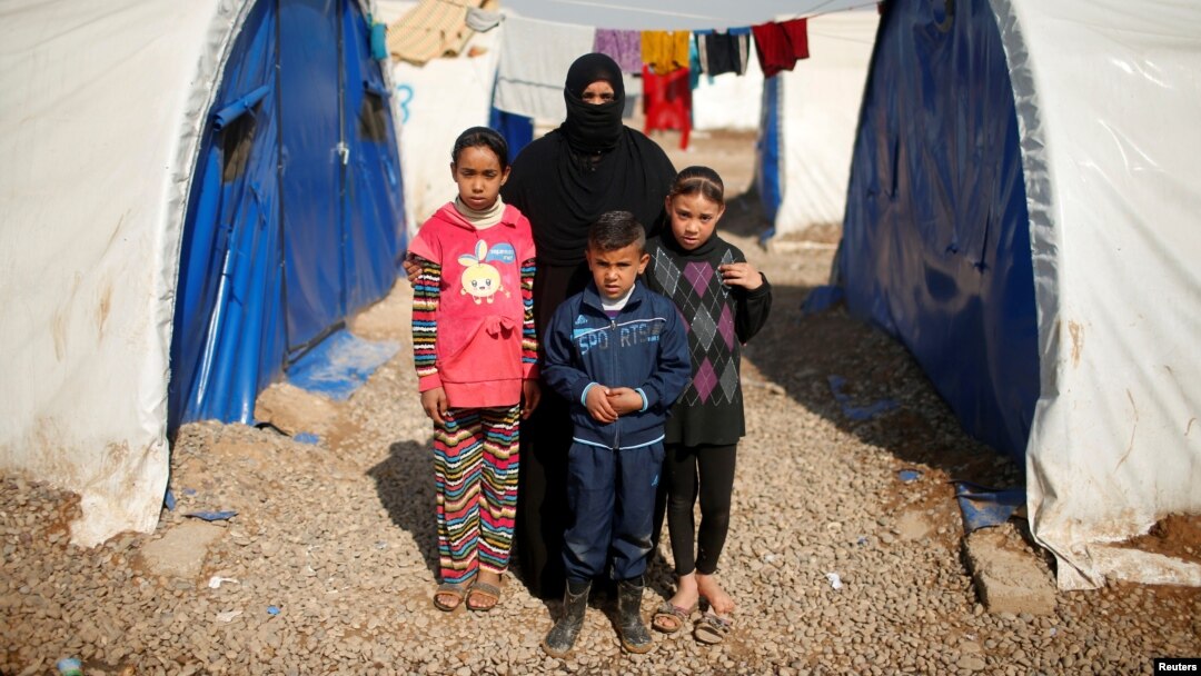 Displaced Iraqi Orouba Abdelhamid, 31, poses for a photograph with her children at Hammam al-Alil camp south of Mosul, Iraq, April 1, 2017. Abdelhamid's husband, an engineer, was killed in a rocket strike as government forces arrived to expel Islamic State from her home city Mosul. "No one is left for me over there so I came here... I cannot return to the house," she said.