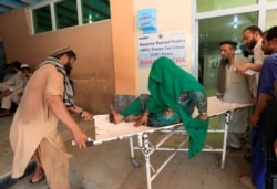 An injured woman receives a treatment at the hospital, after a roadside bomb blast in Jalalabad, Afghanistan, July 25, 2019..