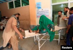 An injured woman receives a treatment at the hospital, after a roadside bomb blast in Jalalabad, Afghanistan, July 25, 2019..