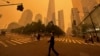 Transeúntes caminan frente al One World Trade Center en medio de la humareda por los incendios forestales de Canadá, el miércoles 7 de junio de 2023, en Nueva York. 
