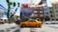 FILE - A yellow taxi drives past a poster depicting Turkey's Prime Minister Tayyip Erdogan in Istanbul.