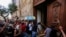 Demonstators smash down a door of the Jalisco State Government Palace in Guadalajara, Mexico, on June 4, 2020, during a protest to demand justice for Giovanni Lopez, who died after being arrested for not wearing a face mask in public.