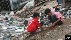 Dua orang anak sedang bermain di dekat sungai yang penuh dengan tumpukan sampah di Jakarta, 22 Maret 2011 (Foto: dok).