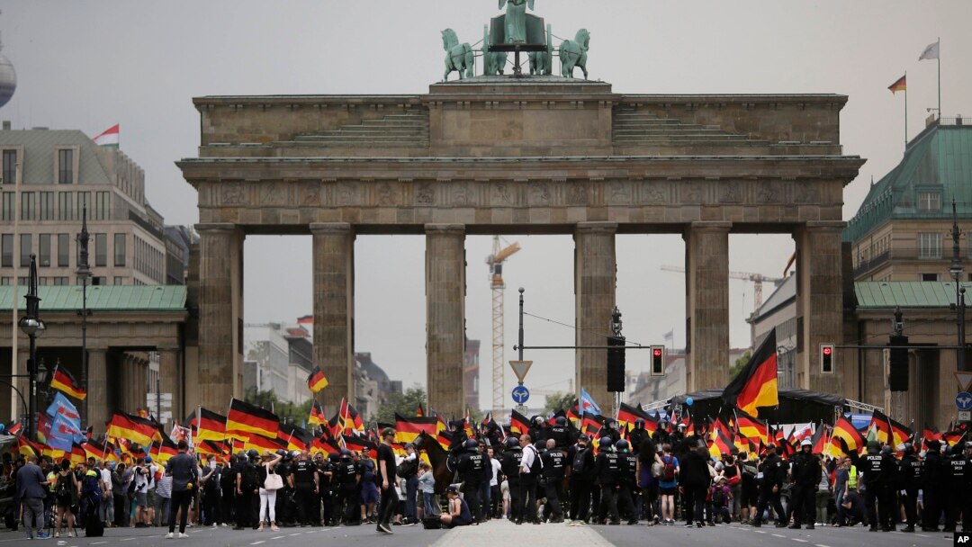 AfD supporters wave flags in front of the Brandenburg Gate in Berlin, Germany, May 27, 2018. The AfD swept into Parliament last year on a wave of anti-migrant sentiment.