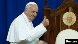 Pope Francis gestures to prisoners at Curran-Fromhold Correctional Facility in Philadelphia, Sept. 27, 2015. 