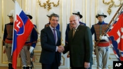 NATO Secretary General Anders Fogh Rasmussen, left, shakes hands with Slovakia's President Ivan Gasparovic, right, as they meet at the Presidential Palace in Bratislava, Slovakia, May 15, 2014. 