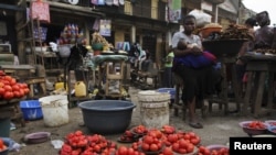 A woman waits for customer at a local food market, in Nigeria's commercial capital Lagos, January 16, 2012. 