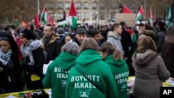 FILE - Demonstrators wear shirts reading "Boycott Israel" during a protest against President Donald Trump's decision to recognize Jerusalem as Israel's capital at Republique Square in Paris, France, Saturday, Dec. 9, 2017. 