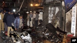 Policemen inspect the site of a bomb explosion at Zaveri bazaar in Mumbai.