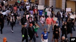 Demonstrators protest over the deaths of George Floyd and Breonna Taylor, June 1, 2020, in Louisville, Ky. Breonna Taylor, a black woman, was fatally shot by police in her home in March.