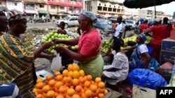 A vendor sells fruit at the large market of Adjame, a popular district of Abidjan, Ivory Coast, Aug. 10, 2017.