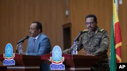 FILE - Lieutenant-General Bacha Debele of the Ethiopian National Defense Force, right, gives a joint press conference with State Minister of Foreign Affairs Redwan Hussein, in Addis Ababa, Ethiopia, June 30, 2021.