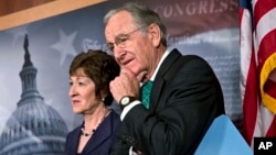 Sen. Tom Harkin, right, stands with Sen. Susan Collins just after the Senate cleared a major hurdle and agreed to proceed to debate a bill that would prohibit workplace discrimination against gay, bisexual and transgender Americans, at the Capitol in Washington, Nov. 4, 2013. 