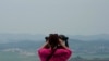 A visitor views the North Korea side from the Unification Observation Post in Paju South Korea, near the border with North Korea, Thursday, June 17, 2021. The North Korea's official Korean Central News Agency said Wednesday, June 16, 2021, that…