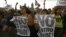 Demonstrators shout slogans as they gather at the Zocalo Plaza in Mexico City, Mexico, July 7, 2012.