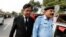 FILE - Saiful Mulook, left, the lawyer for a Christian woman sentenced to death for blasphemy against Islam, leaves after the a court overturned the conviction, in Islamabad, Pakistan, Oct. 31, 2018. 