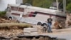 Dominick Gucciardo walks to his home in the aftermath of Hurricane Helene in Pensacola, North Carolina, Oct. 3, 2024.