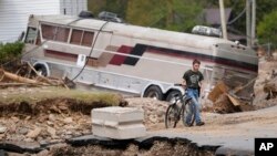 Dominick Gucciardo walks to his home in the aftermath of Hurricane Helene in Pensacola, North Carolina, Oct. 3, 2024.