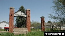 Exterior gate of the former Indian Industrial School in Genoa, Nebraska, which opened in 1884 and continued operating until 1933.