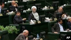 Iranian lawmakers attend an open session of parliament to choose the interim presiding board in Tehran, Iran, May 29, 2016. Iran's long-serving parliament speaker Ali Larijani will retain his post despite gains by reformists in elections held earlier this year, the official IRNA news agency reported Sunday.
