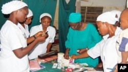 Nigerian midwives receiving obstetrics training.