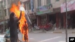 Tibetan Buddhist nun Palden Choetso sets herself ablaze in Daofu, or Tawu in Tibetan, in this still image taken from video shot November 3, 2011.