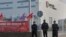 Police guard the entrance of the main Amazon Logistics Center where goods are stored for distribution, on the outskirts of Madrid, Spain, Friday Nov. 22, 2018.