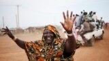 A woman waves to people arriving on vehicles in the town of Abyei ahead of the referendum. Residents of the remote and disputed Abyei border region say they will press on with their own referendum on whether to join Sudan or South Sudan, despite warnings it could trigger violence in the already volatile area. 