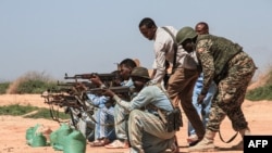 FILE - Ugandan instructors of African Union's peacekeeping mission in Somalia coach Somali soldiers during a training session in Ceeljaale, Somalia, Sept. 19, 2019. 