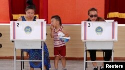 FILE - People vote in country's presidential elections at a polling station in Ulaanbaatar, Mongolia June 26, 2017. 