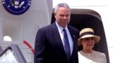 FILE - U.S. Secretary of State Colin Powell steps off the plane with his wife upon his arrival in Nairobi's Jomo Kenyatta International airport, May 26, 2001. 