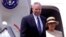 FILE - U.S. Secretary of State Colin Powell steps off the plane with his wife upon his arrival in Nairobi's Jomo Kenyatta International airport, May 26, 2001. 