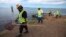 An environmental cleanup crew looks for dead marine life in Keehi Lagoon after a massive molasses spill from a Matson cargo ship in Honolulu, Hawaii, Sept. 12 ,2013.