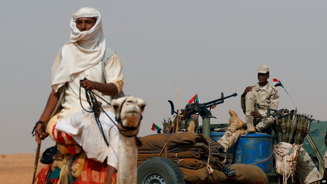 FILE - Gen. Mohammed Hamdan Dagalo, the deputy head of the military council sits on his vehicle surrounded by soldiers from the Rapid Support Forces, RSF, unit during a military-backed tribal rally, in the East Nile province, Sudan, June 22, 2019.
