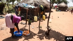 FILE - A South Sudanese refugee washes clothes at the Bidibidi refugee settlement in the Northern District of Yumbe, Uganda, Nov. 26, 2017. 