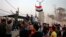 Protesters raise the Iraqi flag at the gate of the Iranian consulate building before storming and burning it in Basra, 340 miles (550 km) southeast of Baghdad, Iraq, Sept. 7, 2018. 