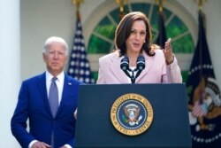 President Joe Biden listens to Vice President Kamala Harris speak in the Rose Garden of the White House, in Washington, Aug. 5, 2021.